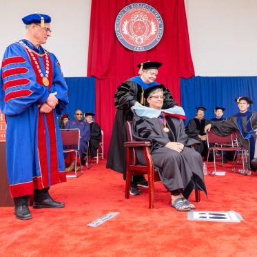 A Phd graduate receiving their hood