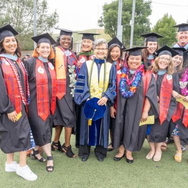 Graduating students standing together smiling